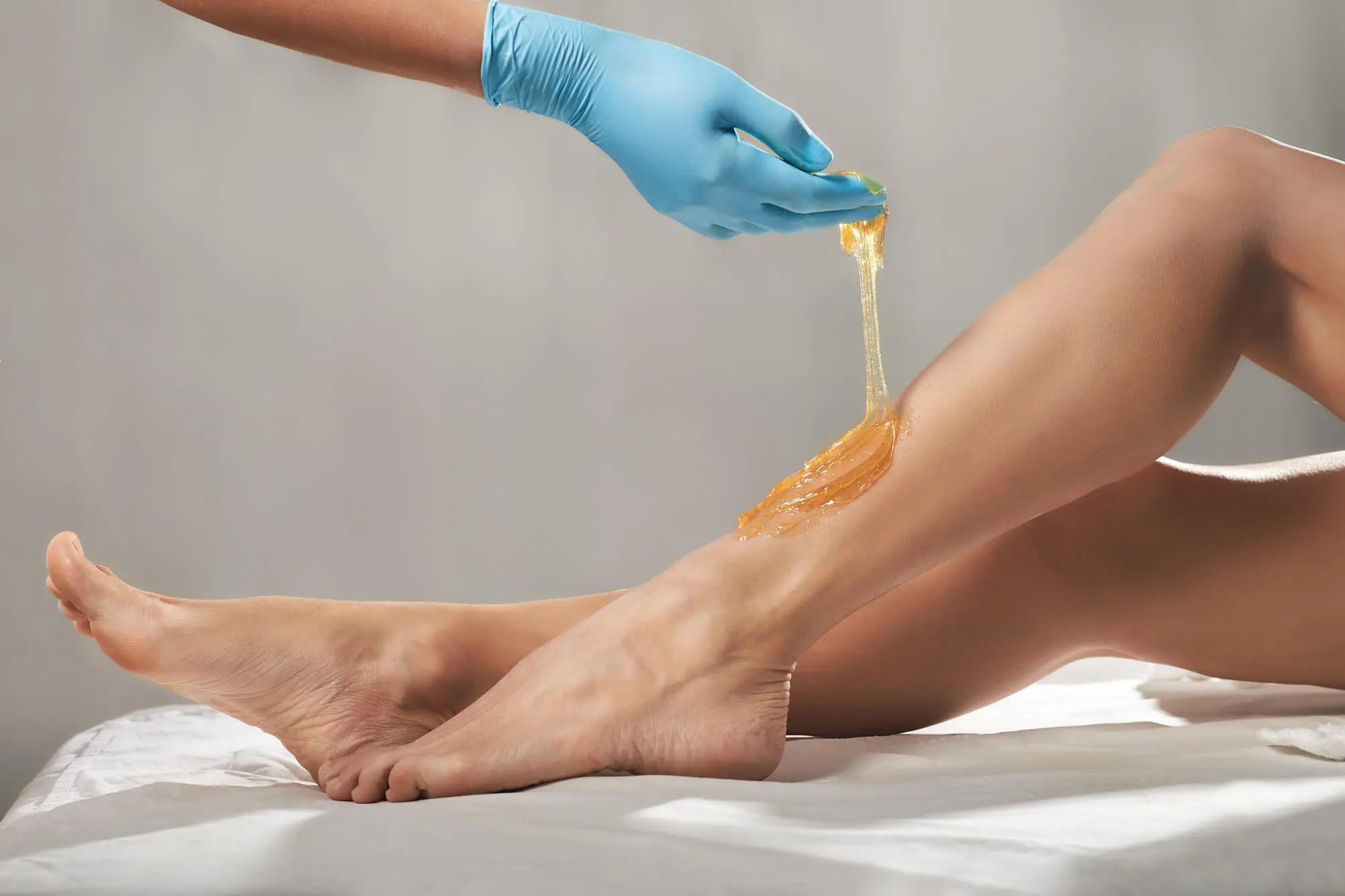 Applying wax to a leg